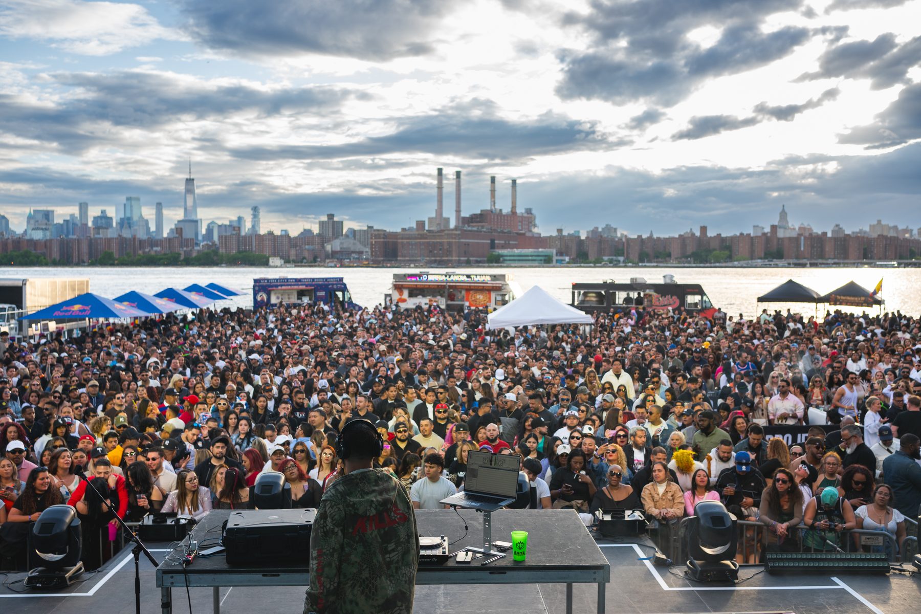 Crowd gathered at an outdoor stage on a cloudy afternoon
