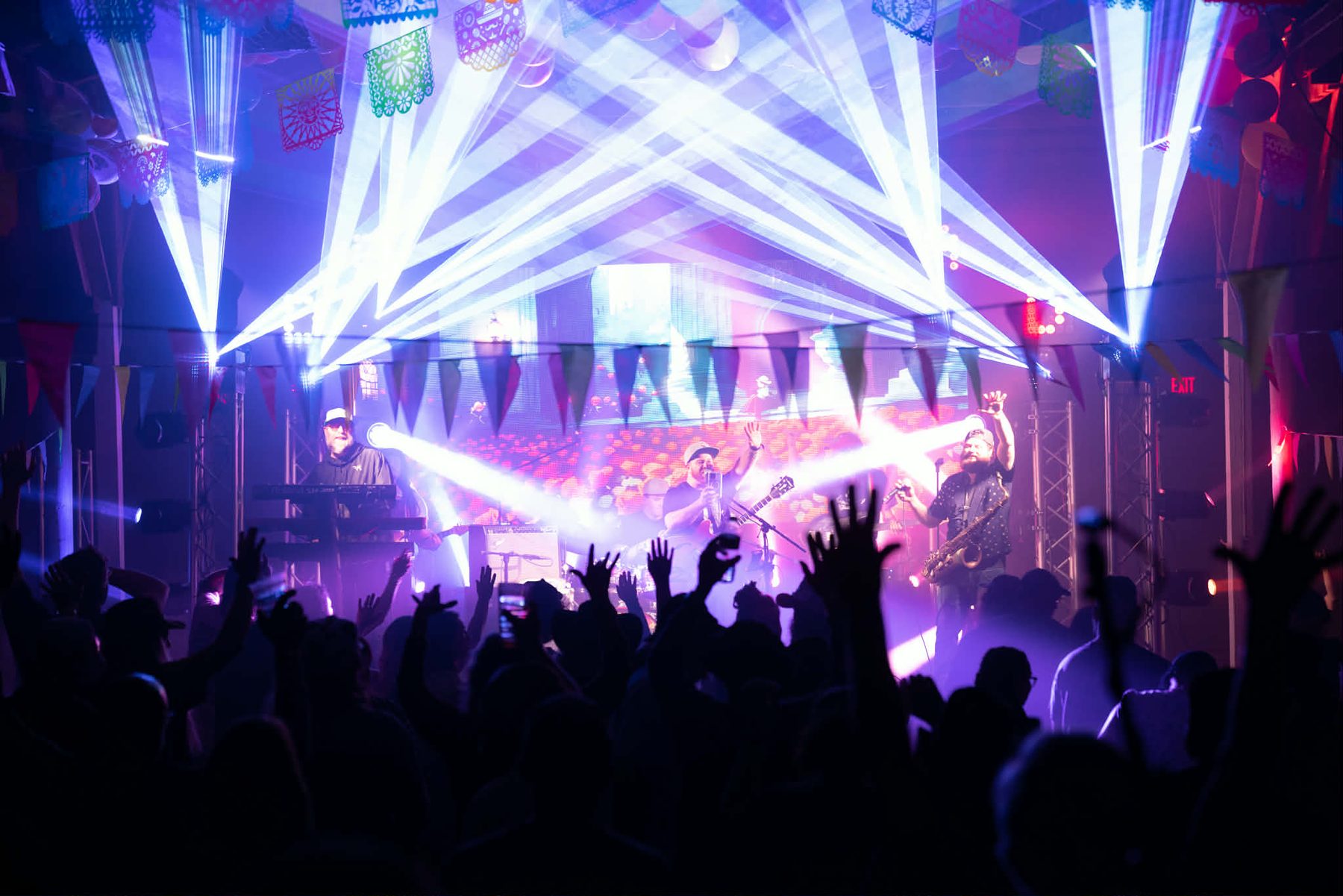 Circus of Life Music Festival indoor stage with beams of light over the crowd
