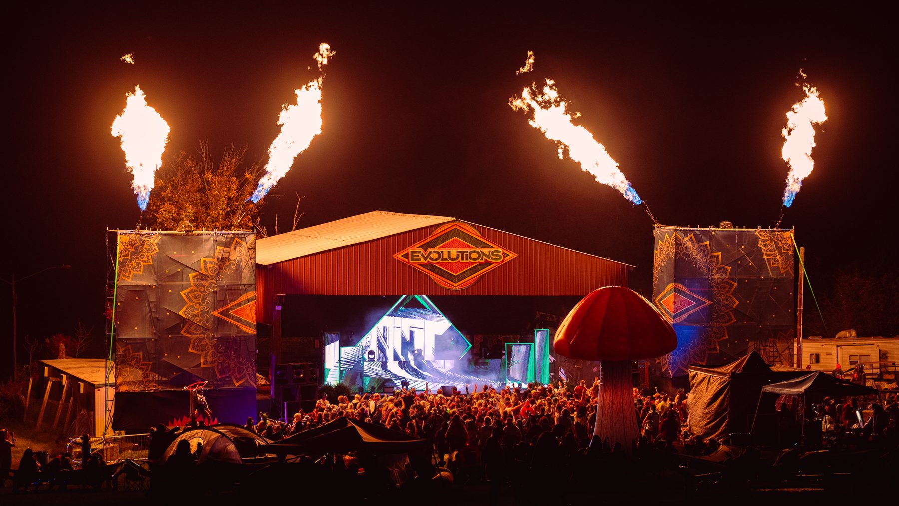 Evolutions Music Festival stage with flame effects and LED video at night